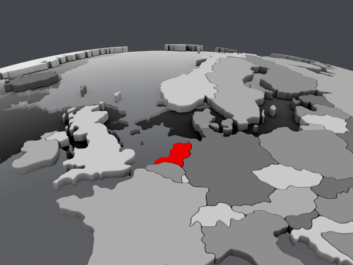 Close-up of a world globe with countries shaded in grey nuances, highlighting the Netherlands in red.