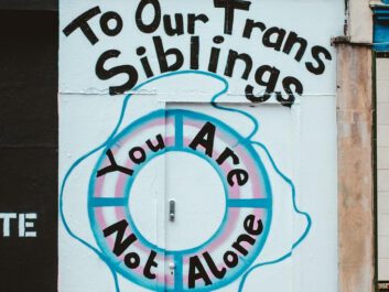 Writing on a wall saying, 'To Our Trans Siblings - You Are Not Alone'