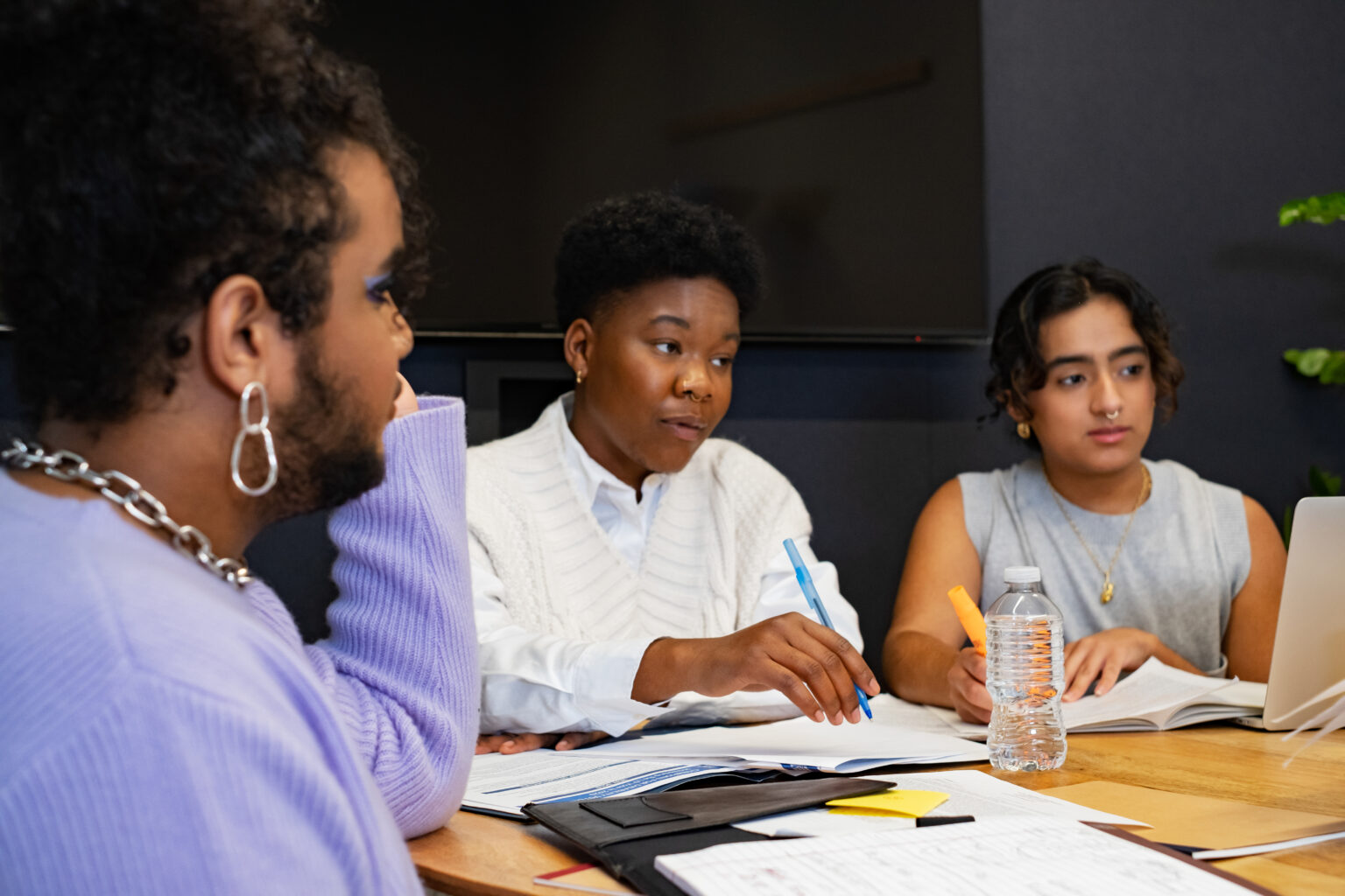 A group of co-workers of varying genders having a meeting