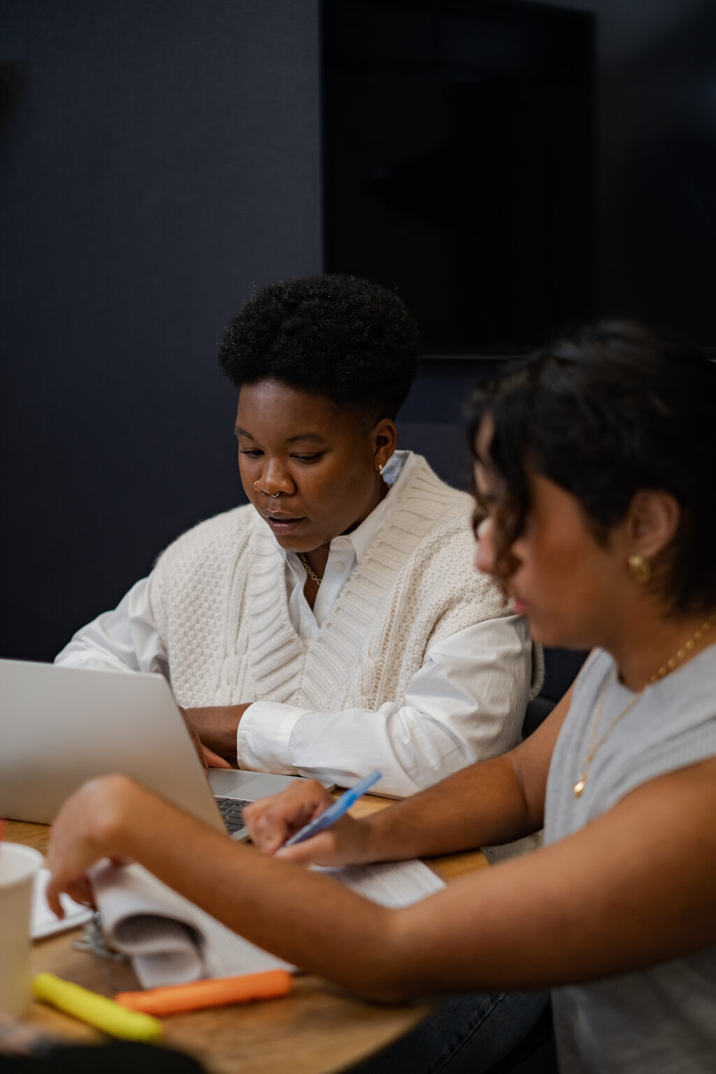 A trans person and a trans man working in a meeting.