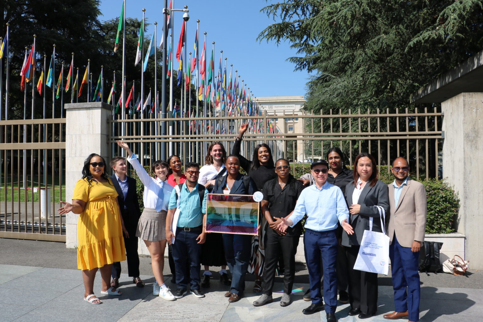 Trans Advocacy Week 2025 participants standing in front of the UN headquarter cheering