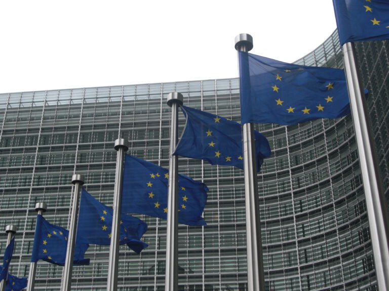 EU flags flying in front of the EU commission building